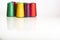 Colored industrial spools arranged on white background