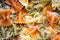 Colored italian cooked pasta farfalle tricolore abstract backdrop.