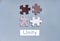 Colored Jigsaw Puzzle pieces on gray background top view. Concept for Unite to end racism. Symbol of association and