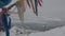 Colored khadak ribbons on the tree of desires and a group of people descending the hill to the ice-covered Lake Baikal