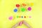 Colored mass for modeling, plasticine for children`s creativity, the child makes colored geometric shapes,  yellow background