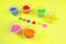 Colored mass for modeling, plasticine for children`s creativity, the child makes colored geometric shapes,  yellow background