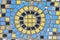 Colored mosaic and round tile pattern on the old wall. decorative mosaic in blue, yellow and black colors