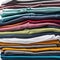 Colored multi-colored T-shirts lie in a stack