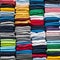 Colored multi-colored T-shirts lie in a stack. Concept of diversity in the world