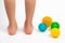 colored needle balls for massage and physiotherapy on a white background with the image of children& x27;s feet, the concept