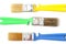 Colored paint brushes with plastic handles on a white background, isolate, flat layer, close-up