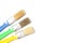 Colored paint brushes with plastic handles on a white background, place for text, isolate, flat layer, close-up