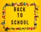 Colored paper clips, clothespin on yellow background. Back to school text