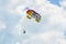 Colored parasail wing in the blue clouds sky, Parasailing