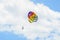 Colored parasail wing in the blue clouds sky, Parasailing