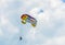 Colored parasail wing in the blue clouds sky, Parasailing