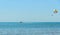 Colored parasail wing pulled by a boat in the sea water, Parasailing