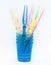 Colored party sticks in colored blue cups on a white background