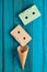 Colored pastel audio cassette and empty waffle horn on a blue wooden background. Top view, minimalist trend