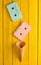 Colored pastel audio cassette and empty waffle horn on a yellow wooden background. Top view, minimalist trend