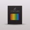 Colored Pencils in black paper packaging with a transparent window isolated on light grey background