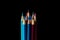 Colored pencils on black reflection stacked education school kids art