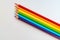 Colored pencils with LGBT gay pride colors tilted up on white background
