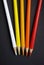 Colored pencils over black background. Warm colors. White, yellow, orange and red.