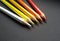 Colored pencils over black background. Warm colors. White, yellow, orange and red.