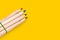 Colored pencils on a yellow background with a copy of the space. A set of pencils for drawing and creativity. Tools for school