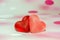 Colored (pink, red and orange), transparent heart shape jellies, colored degradee background