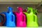 Colored plastic watering spray cans on the shelf