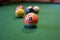 Colored pool balls on a green pool table