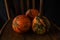 Colored pumpkins on wooden chair. Autumn scene