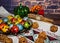 Colored quail eggs in a plate on a tablecloth with pumpkin, cinnamon and mountain ash