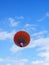 Colored red balloon with people flying into the sky with clouds. Little balloon adventure