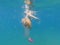 Colored ribbed jellyfish comes dangerously close to a swimmer