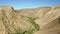 Colored rocks . Flying over red rock formation in Southern mountains. Aerial shot, 4K.