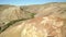 Colored rocks . Flying over red rock formation in Southern mountains. Aerial shot, 4K.