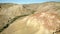 Colored rocks . Flying over red rock formation in Southern mountains. Aerial shot, 4K.