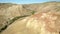 Colored rocks . Flying over red rock formation in Southern mountains. Aerial shot, 4K.