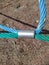 colored rope cables fastened together with a metal fastener