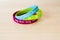 Colored rubber bracelets with inscriptions on beige background