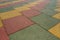 Colored rubber square paving slab for playgrounds close-up.