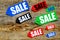 Colored sale labels on dark wooden background top view