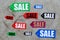 Colored sale labels on light stone background top view