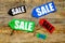 Colored sale labels on wooden background top view