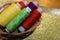 Colored sewing threads in a blur basket background