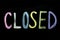 Colored sign closed on chalkboard