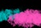 Colored smoke isolated on a black background. Blue and pink clouds template. Background from the smoke of vape