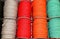 colored spools of thread and balls of wool for sale in the shop