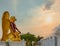 Colored statue of eagle god or Garuda with beautiful sky of senset time