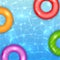 Colored Swim Rings on Water Background