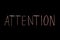 Colored text `attention` written  on chalkboard